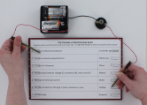 Place one probe on the paper clip